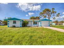 Newly renovated home with blue accents and a spacious yard at 105 Sylvania Ave, Englewood, FL 34223