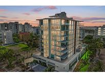 Modern high-rise building with city views at sunset at 111 Golden Gate Pt # 402, Sarasota, FL 34236