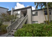 Condo building entry with stairs and landscaping at 1508 Pelican Cove Rd # Gr233, Sarasota, FL 34231