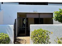 Exterior view of condo with gated entry and landscaping at 3500 El Conquistador Pkwy # 331, Bradenton, FL 34210