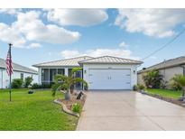 Single story home with attached garage and landscaped yard at 400 Baytree Dr, Rotonda West, FL 33947