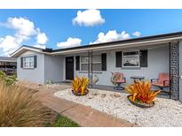 Updated home exterior, featuring a landscaped front yard with seating at 138 Paddington Rd, Venice, FL 34293