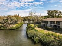 Scenic aerial view of the waterfront condos and lush landscaping around the peaceful community at 1519 Pelican Point Dr # 292, Sarasota, FL 34231