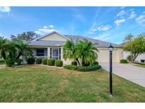 Single-story home with landscaped lawn at 2467 E Del Webb Blvd, Sun City Center, FL 33573