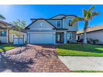 Two-story home with gray siding and brick accents at 15277 Mille Fiore Blvd, Port Charlotte, FL 33953