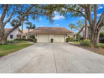 Front view of a two-car garage villa with landscaping at 3375 Sandleheath # 34, Sarasota, FL 34235