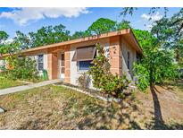 Tan-colored single-story home with lush landscaping at 630 N Jefferson Ave # 19, Sarasota, FL 34237