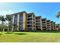 Attractive condo building with lush landscaping at 8779 Midnight Pass Rd # 206H, Sarasota, FL 34242