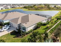 Aerial view of home with mature landscaping, screened-in pool, and pond view at 16606 Barnwood Pl, Bradenton, FL 34211