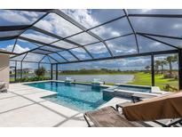 Relaxing pool area with spa, lounge chairs, and serene water views at 16606 Barnwood Pl, Bradenton, FL 34211