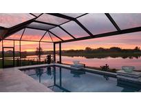 Enclosed pool with waterfront views and sunset at 16606 Barnwood Pl, Bradenton, FL 34211