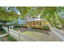 Charming yellow home with a white picket fence and covered front porch at 1920 Laurel St, Sarasota, FL 34236
