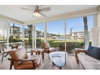 Bright sunroom with water views and comfortable seating at 4340 Falmouth Dr # D104, Longboat Key, FL 34228