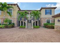 Two-story building with stone facade and brick driveway at 13604 Messina Loop # 103, Lakewood Ranch, FL 34211