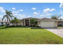 Beautiful house exterior with lush lawn at 23095 Langdon Ave, Port Charlotte, FL 33954