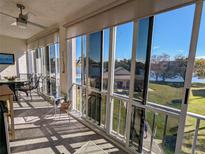 Spacious lanai with sliding glass doors and water view at 3935 Lake Bayshore Dr # F-316, Bradenton, FL 34205