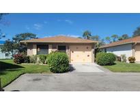 Brick ranch home with attached garage and landscaped yard at 4924 Live Oak Cir # 115, Bradenton, FL 34207