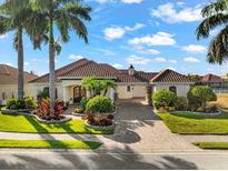 Inviting home with lush landscaping and a brick driveway at 536 Mast Dr, Bradenton, FL 34208