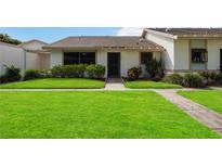 Front view of a condo with well-maintained lawn at 6515 Heritage Ln # 2615, Bradenton, FL 34209