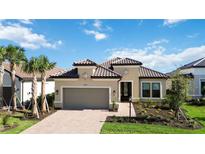 Tan house with brown roof, two-car garage, and palm trees at 10128 Morning Mist Ln, Sarasota, FL 34241