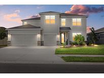 Two-story house with three-car garage and landscaping at 17015 Harvest Moon Way, Bradenton, FL 34211