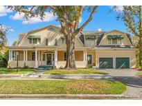 Large two-story home with a wrap-around porch and two-car garage at 810 S Edison Ave, Tampa, FL 33606
