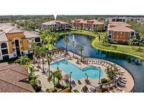 Community resort-style pool with a fountain and plenty of lounge space at 8377 38Th Street E Cir # 308, Sarasota, FL 34243