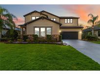 Two-story house with stone accents and a landscaped lawn at 13148 Bliss Loop, Bradenton, FL 34211