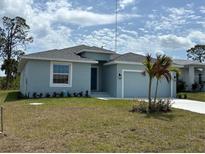 Charming single-story home features a manicured lawn and an attached two-car garage at 160 Apollo Dr, Rotonda West, FL 33947