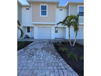 Two-story townhome with attached garage and paved driveway at 2533 6Th Ave Drive E # 2, Bradenton, FL 34208