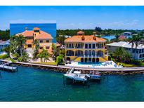 Stunning waterfront home with a private dock, swimming pool, and lush landscaping at 309 Ringling Point Dr, Sarasota, FL 34234