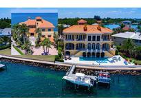Stunning waterfront home boasts private dock, pool, and Mediterranean architecture at 309 Ringling Point Dr, Sarasota, FL 34234