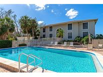 Inviting swimming pool with surrounding lounge chairs and patio furniture at 5201 Gulf Of Mexico Dr # 104, Longboat Key, FL 34228