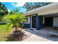 Charming house exterior with a navy blue facade and landscaping at 560 Bradenton Rd, Venice, FL 34293