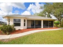 Enjoy outdoor living on this property’s charming screened patio with a meticulously maintained yard at 31730 Clay Gully Rd, Myakka City, FL 34251