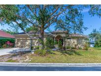 One-story house with a large tree in front and a paved walkway at 3970 Serenity Cir, Sarasota, FL 34235