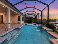 Stunning pool with waterfalls in a screened enclosure offers a relaxing outdoor experience at 5058 Surfside Cir, Lakewood Ranch, FL 34211