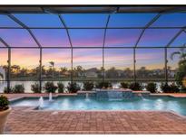 Stunning pool and spa with fire pit at sunset at 5058 Surfside Cir, Lakewood Ranch, FL 34211