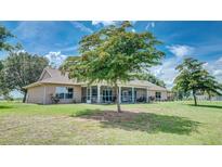 Spacious backyard with screened porch and lush lawn at 560 Oakford Rd, Sarasota, FL 34240