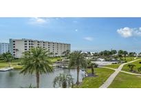 Beautiful waterfront view with a resort-style pool and lush landscaping at 5760 Midnight Pass Rd # 307D, Sarasota, FL 34242