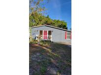 Cute bungalow with red door, landscaping, and a bird bath at 601 27Th W St, Bradenton, FL 34205