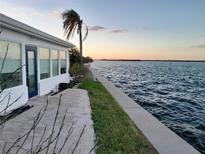 Spacious waterfront patio with brick pavers and water views at 957 Spanish N Dr, Longboat Key, FL 34228