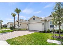 New home exterior with a two-car garage and well-maintained landscaping at 16106 Bridle Ridge St, Port Charlotte, FL 33953