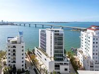 Aerial view of waterfront property with modern high-rise buildings and bridge at 280 Golden Gate Pt # 600, Sarasota, FL 34236