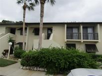 Condo building exterior with lush landscaping and parking at 4546 Longwater # 44, Sarasota, FL 34235