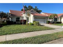 Charming single-story home with a tile roof, well-manicured lawn and two car garage at 4872 Limetree Ln, Venice, FL 34293