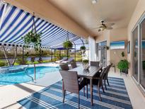 Relaxing pool area with patio furniture, hot tub, and screened enclosure at 6828 Coyote Ridge Ct, University Park, FL 34201