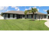 Single-story home with gray exterior, landscaping, and two-car garage at 1820 E Leewynn Dr, Sarasota, FL 34240