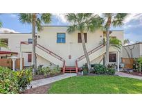 Front view of condo building with stairs and landscaping at 304 Spring Lakes Blvd # 304, Bradenton, FL 34210