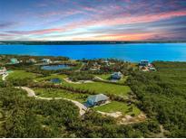 Aerial view of waterfront property with houses and lush greenery at 445 Horseshoe Loop Rd, Terra Ceia, FL 34250